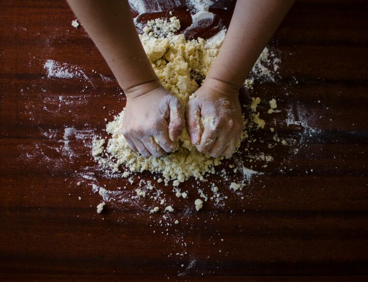 Person Mixing Dough